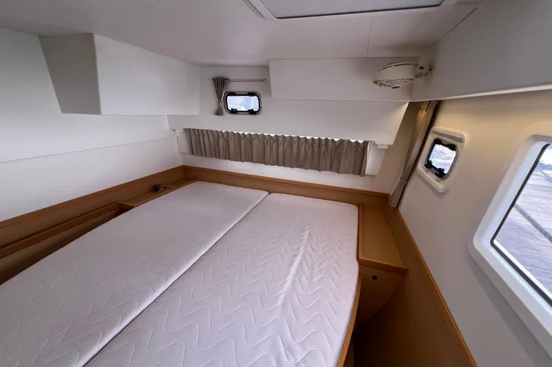 Mocean Yacht Photos Pics Interior cabin of 2017 Lagoon 42 catamaran with bed and windows.