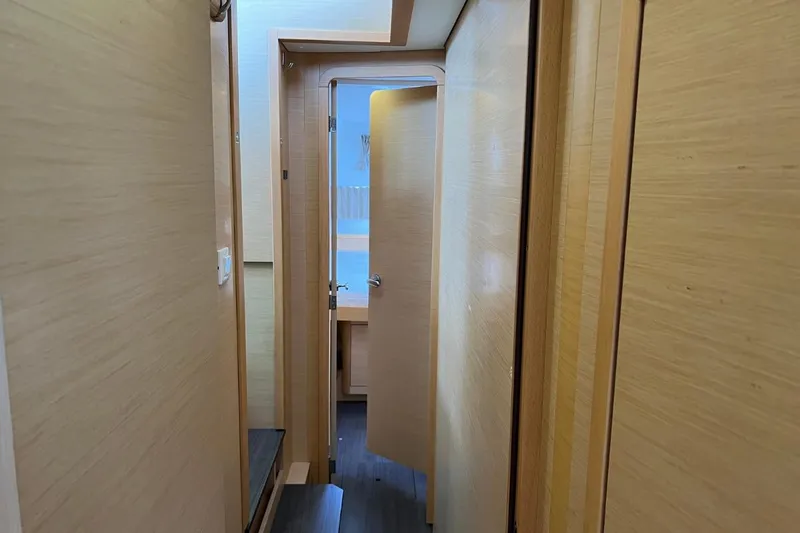 Mocean Yacht Photos Pics Interior hallway of 2017 Lagoon 42 catamaran with wooden paneling and open door.