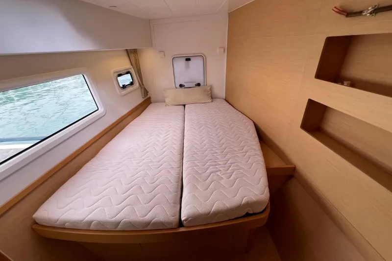Mocean Yacht Photos Pics Interior cabin of 2017 Lagoon 42 catamaran with twin beds and porthole view.