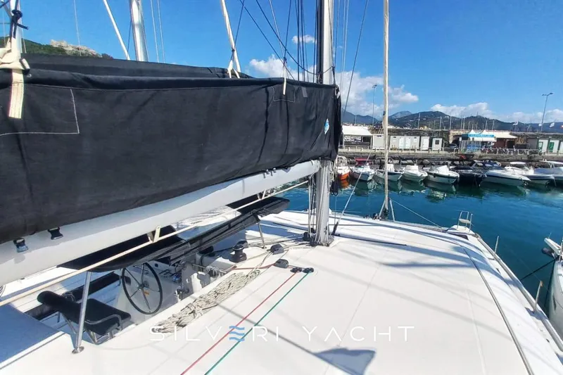  Yacht Photos Pics 2019 Lagoon 42 yacht docked at marina, featuring sleek deck and black sail cover.
