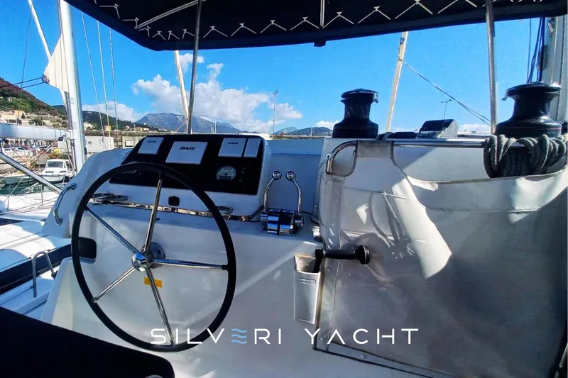  Yacht Photos Pics Helm of 2019 Lagoon 42 yacht with navigation equipment and scenic marina view.