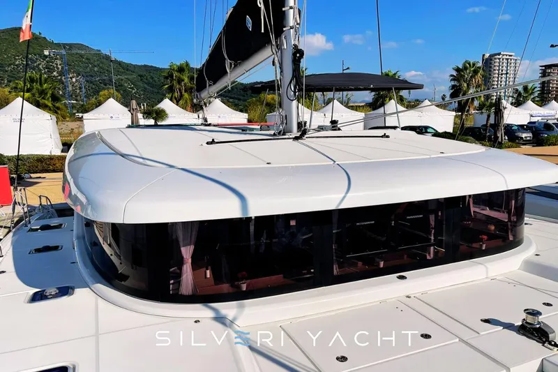  Yacht Photos Pics 2019 Lagoon 42 yacht with sleek design, docked under clear blue sky.