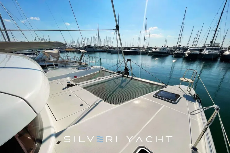  Yacht Photos Pics 2019 Lagoon 42 catamaran docked at marina, sunny day, Silveri Yacht branding.