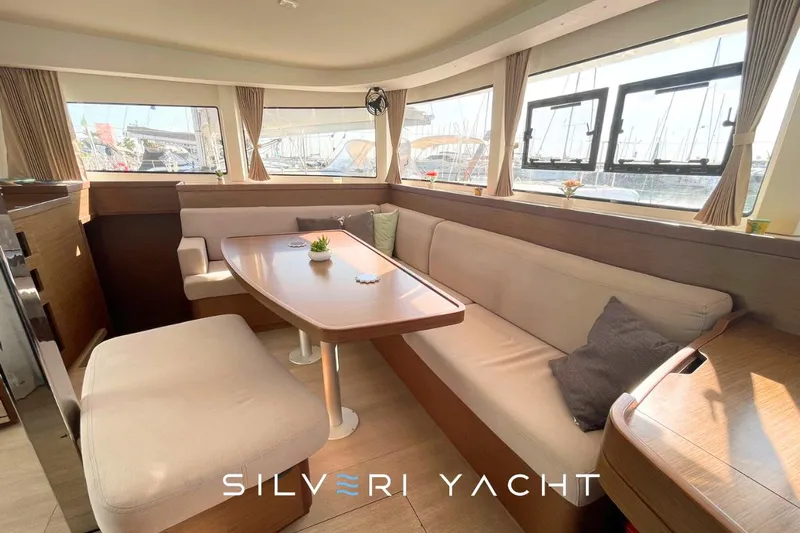  Yacht Photos Pics Interior of 2019 Lagoon 42 yacht with elegant seating and dining area.