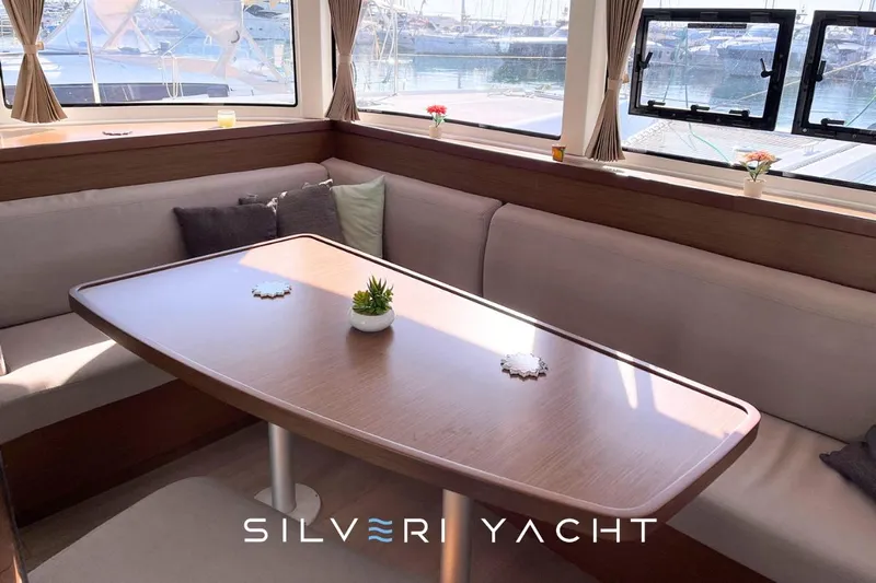  Yacht Photos Pics Interior of 2019 Lagoon 42 yacht with elegant dining area and panoramic windows.