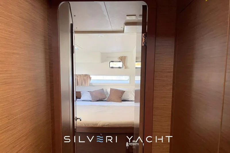  Yacht Photos Pics Luxurious cabin interior of 2019 Lagoon 42 yacht with cozy bedding.