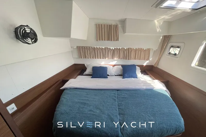  Yacht Photos Pics Cozy bedroom interior of 2019 Lagoon 42 yacht with double bed and natural light.