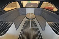 2024 Maxima 740 boat interior with sleek seating and central table.