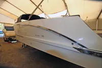 2024 Maxima 740 boat in storage, sleek design, under a protective canopy.