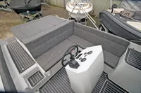 2024 Maxima 740 boat interior with gray seating and modern steering console.