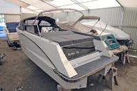 2024 Maxima 740 boat in storage, featuring sleek design and spacious seating.