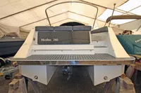 2024 Maxima 740 boat in storage, rear view with seating and deck.