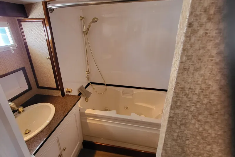 Savoy Yacht Photos Pics 1970 Chris-Craft Commander bathroom with sink, countertop, and bathtub with showerhead.