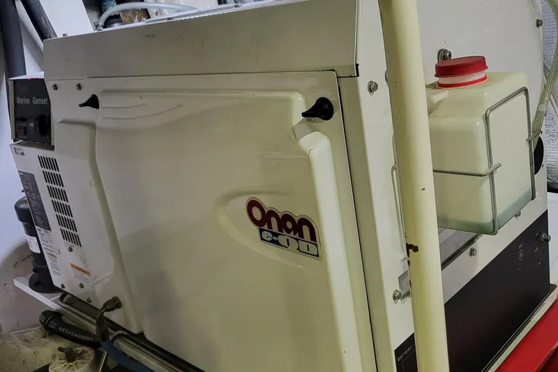 Savoy Yacht Photos Pics 1970 Chris-Craft Commander with Onan marine generator, featuring a compact design and white casing.