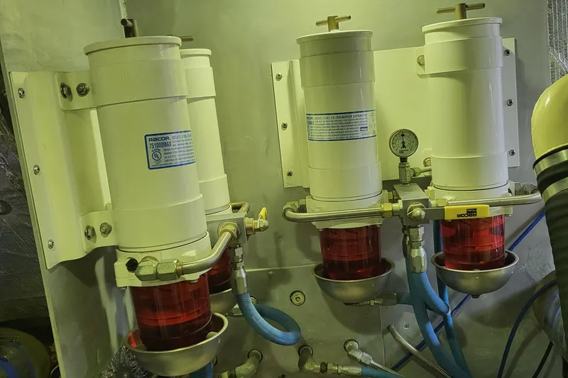 Savoy Yacht Photos Pics Engine room filters on a 1970 Chris-Craft Commander boat, featuring red and white components.