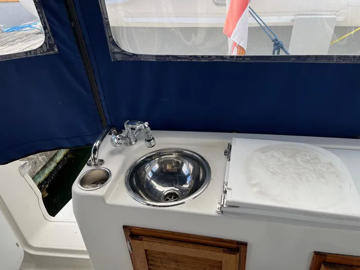  Yacht Photos Pics Compact sink area on 2012 Ranger Tugs R-29 boat with blue canopy.