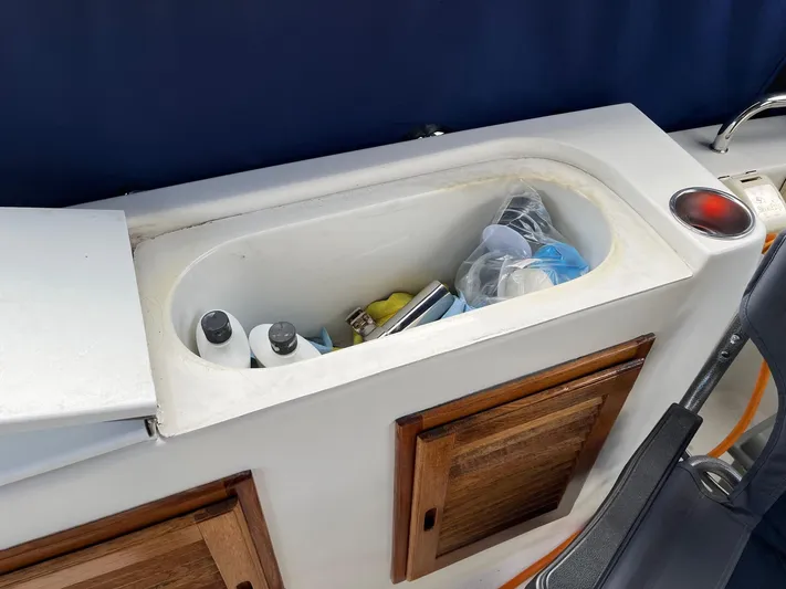  Yacht Photos Pics Storage compartment on a 2012 Ranger Tugs R-29 boat with various items inside.
