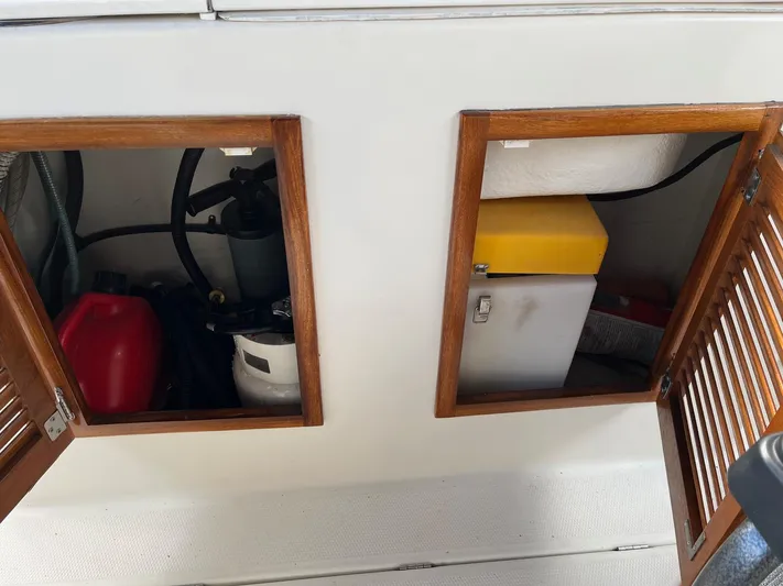  Yacht Photos Pics Open storage compartments on a 2012 Ranger Tugs R-29 boat, showing equipment and supplies.