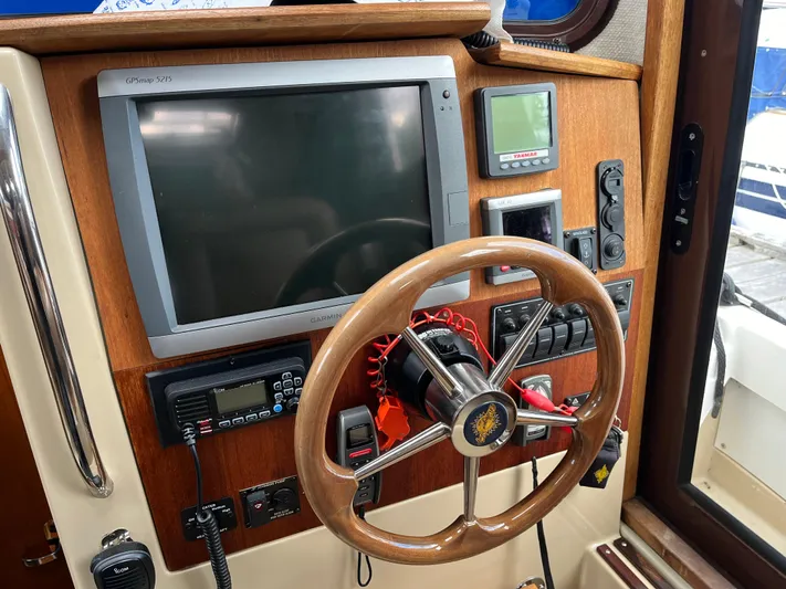  Yacht Photos Pics 2012 Ranger Tugs R-29 helm with steering wheel, navigation screen, and control panel.