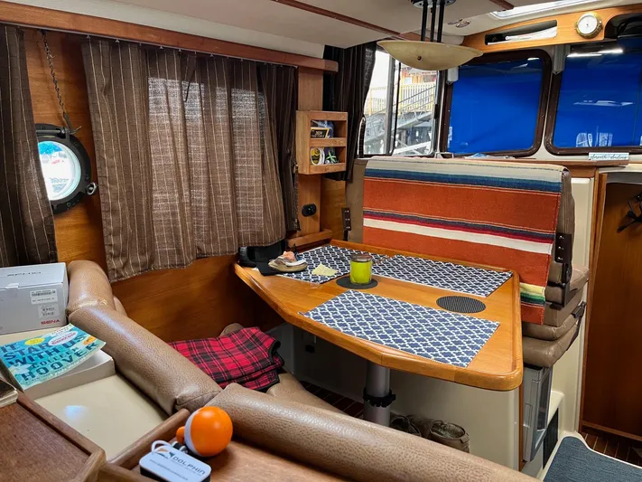 Yacht Photos Pics Interior of 2012 Ranger Tugs R-29 boat with cozy dining area and nautical decor.