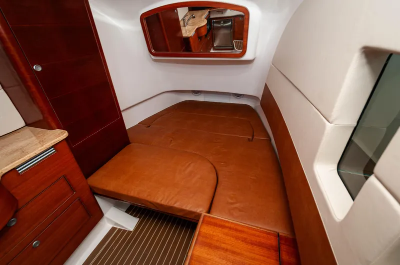 Yolo 2 Yacht Photos Pics 2015 Edgewater 368 CC cabin interior with brown leather seating and wood accents.