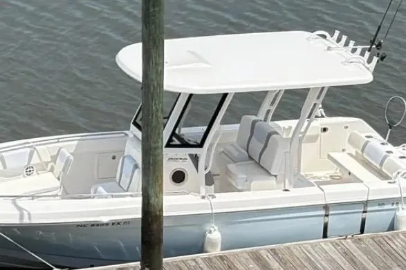  Yacht Photos Pics 2022 Robalo R272 Center Console boat docked on calm water.