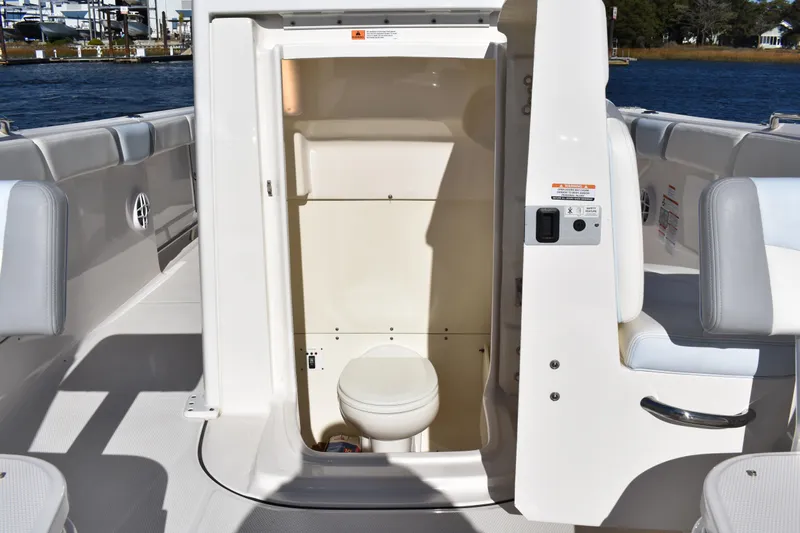  Yacht Photos Pics 2022 Robalo R272 Center Console boat with open marine toilet compartment.