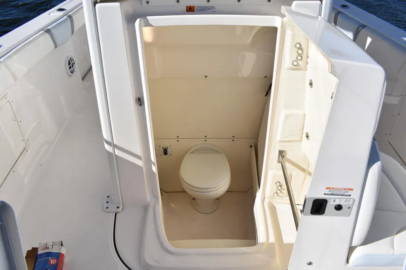  Yacht Photos Pics 2022 Robalo R272 Center Console boat with onboard toilet compartment.