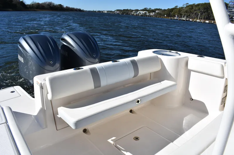  Yacht Photos Pics 2022 Robalo R272 Center Console boat with twin Yamaha engines on a calm lake.