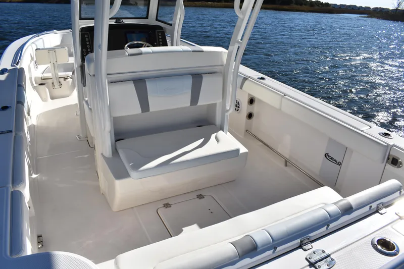  Yacht Photos Pics 2022 Robalo R272 Center Console boat interior on water, showcasing seating and console.