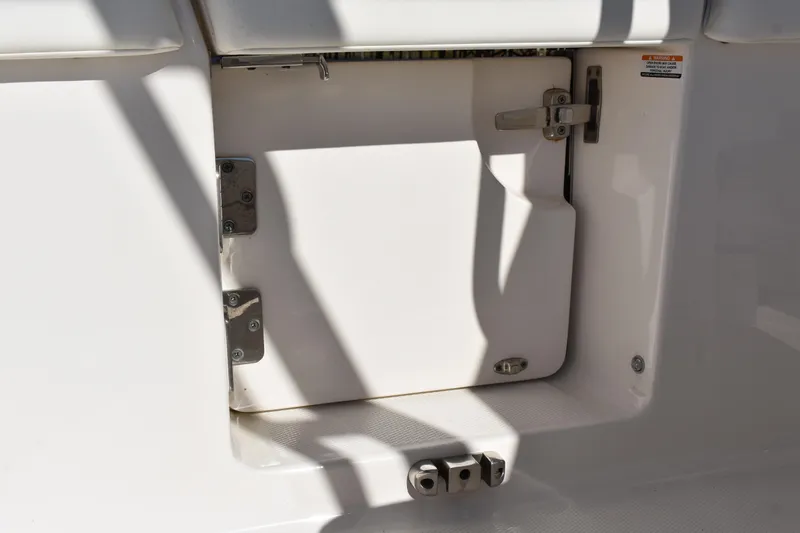  Yacht Photos Pics 2022 Robalo R272 Center Console storage compartment with secure latch and hinges.
