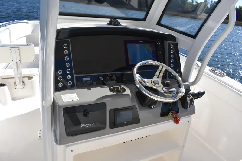  Yacht Photos Pics 2022 Robalo R272 Center Console boat dashboard with steering wheel and navigation display.