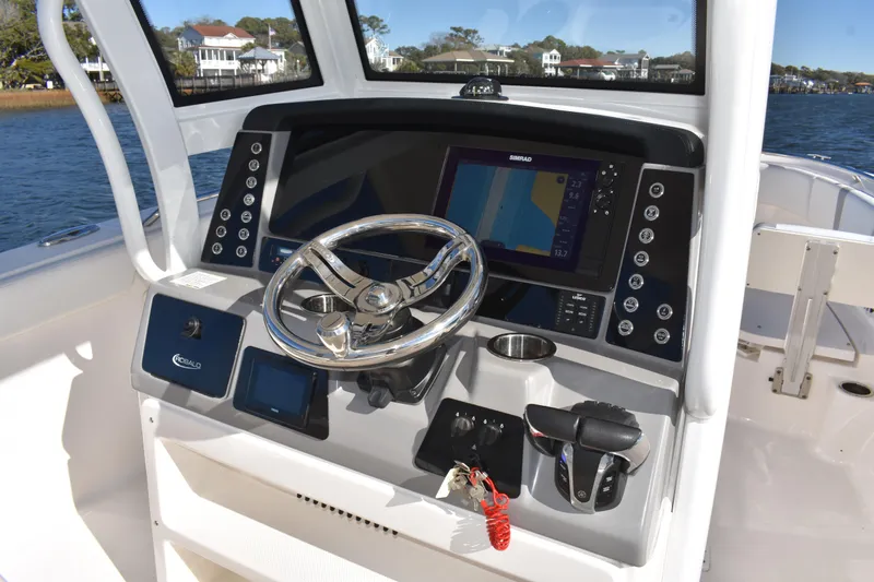  Yacht Photos Pics 2022 Robalo R272 Center Console boat dashboard with steering wheel and navigation display.
