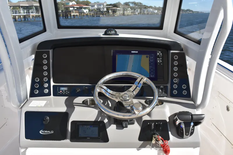  Yacht Photos Pics 2022 Robalo R272 Center Console boat dashboard with steering wheel and navigation display.