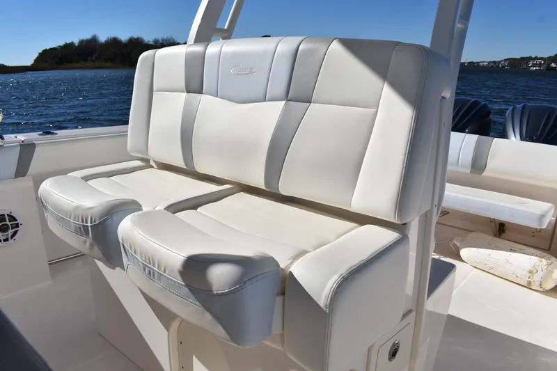  Yacht Photos Pics 2022 Robalo R272 Center Console boat with white cushioned seating.