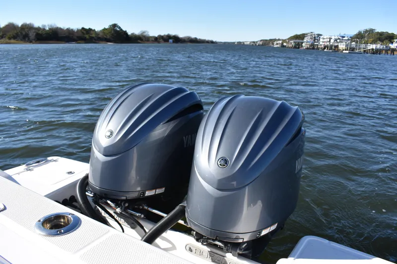  Yacht Photos Pics 2022 Robalo R272 Center Console with dual Yamaha outboard engines on a scenic waterway.