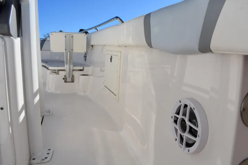  Yacht Photos Pics 2022 Robalo R272 Center Console boat interior with speaker and storage compartment.