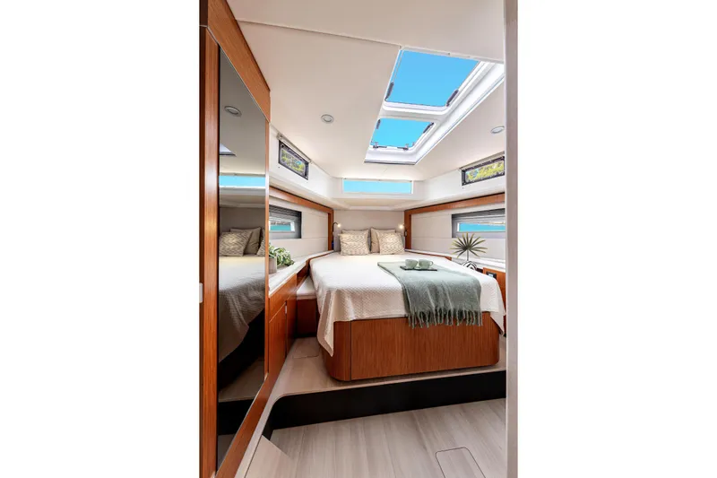  Yacht Photos Pics Luxurious cabin interior of 2026 Moody 48DS yacht with skylights and elegant decor.