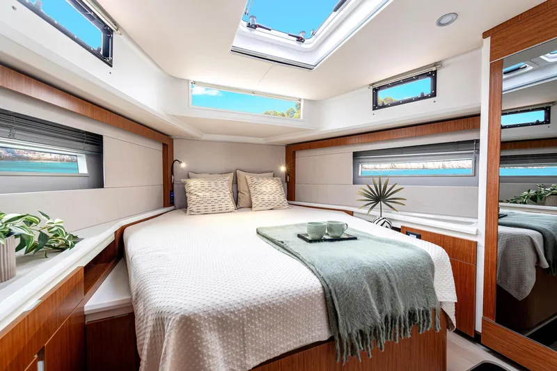  Yacht Photos Pics Luxurious cabin interior of 2026 Moody 48DS yacht with skylight and elegant decor.