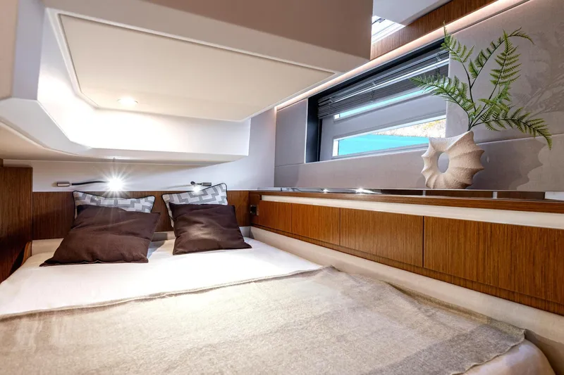  Yacht Photos Pics Luxurious cabin interior of 2026 Moody 48DS yacht with modern decor and cozy bedding.