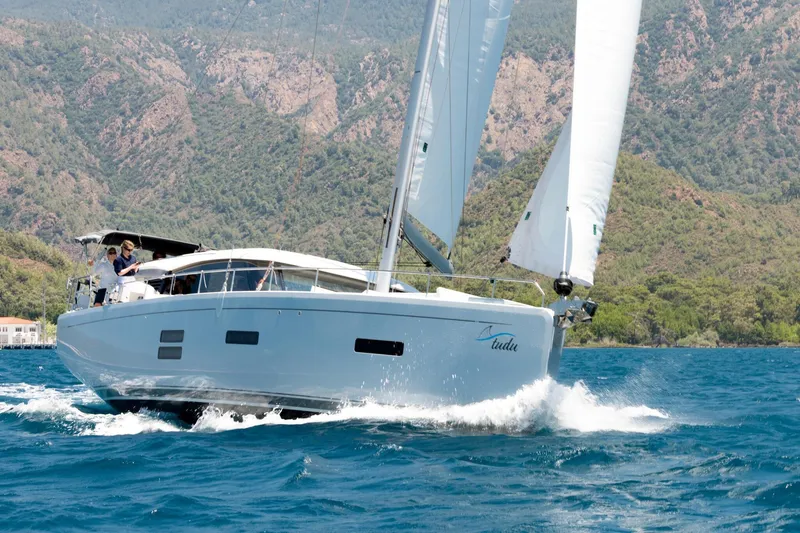  Yacht Photos Pics Sailing yacht Moody 48DS 2026 cruising on blue waters with scenic mountain backdrop.