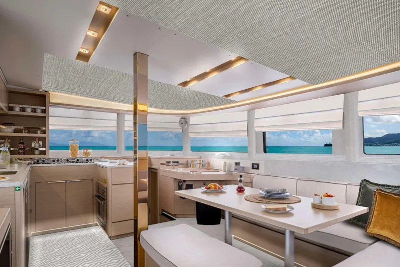  Yacht Photos Pics Luxurious interior of 2026 Moody 48DS yacht with ocean view, modern kitchen, and dining area.