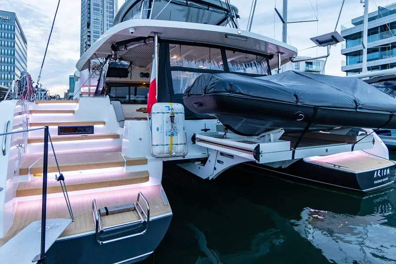  Yacht Photos Pics Luxurious 2026 Moody 48DS yacht docked, featuring illuminated steps and sleek design.
