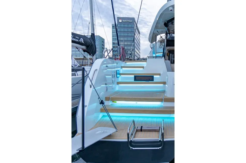  Yacht Photos Pics Sleek Moody 48DS yacht with illuminated steps, docked in urban marina, 2026 model.