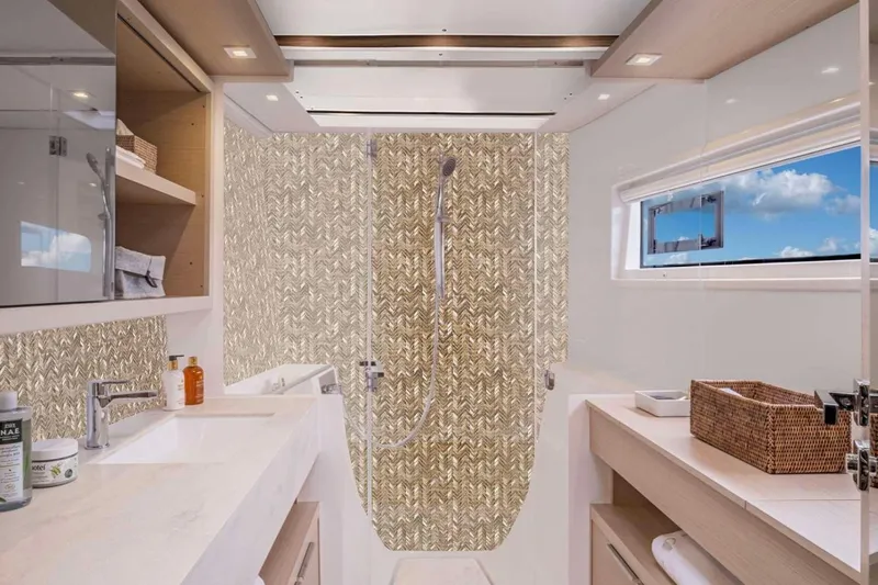  Yacht Photos Pics Luxurious bathroom in 2026 Moody 48DS yacht with modern fixtures and ocean view.