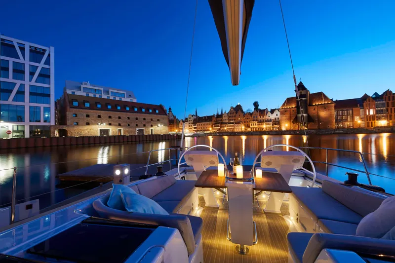  Yacht Photos Pics Luxurious Moody 48DS yacht at sunset, cityscape reflecting on calm water, 2026 model.