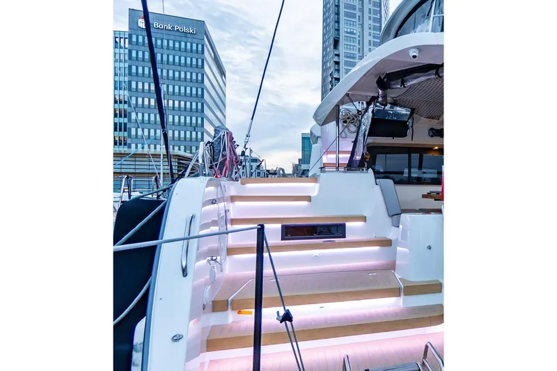  Yacht Photos Pics Modern Moody 48DS yacht with illuminated steps, docked near urban buildings, 2026 model.