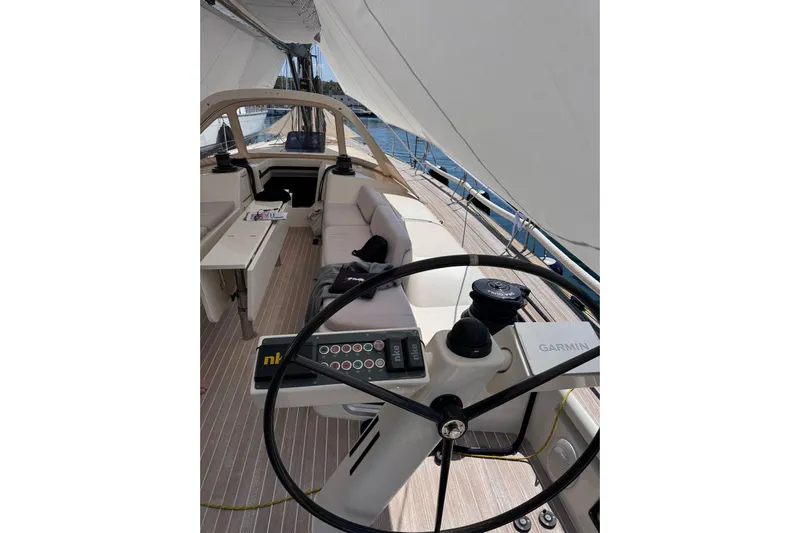  Yacht Photos Pics Cockpit of 2012 Nautor Swan 60 yacht with steering wheel and seating area.