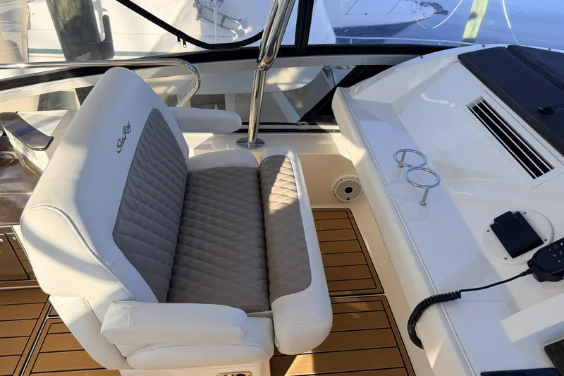  Yacht Photos Pics Captain's seat on 2012 Sea Ray 450 Sedan Bridge yacht, featuring elegant design and controls.