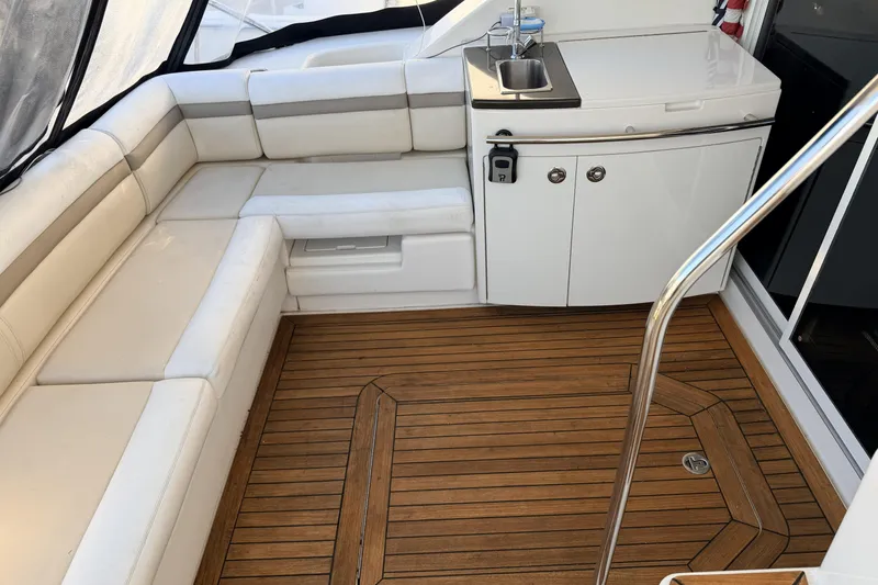  Yacht Photos Pics Luxurious 2012 Sea Ray 450 Sedan Bridge interior with white seating and teak flooring.